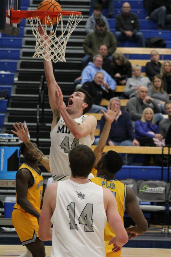 Mines junior forward Riley Schroeder (44) attempts a first-half layup over Fort Lewis defenders during the Jan. 27 game at Colorado School of Mines. Fort Lewis won 93-87.